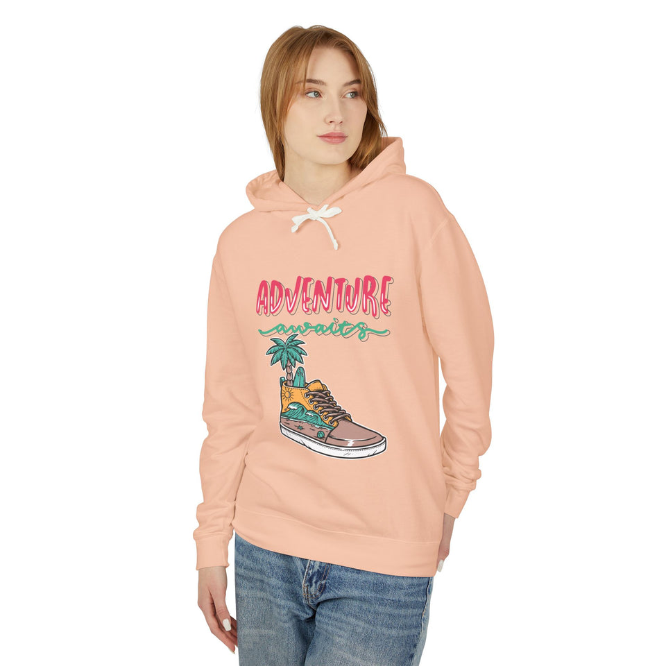 Teen girl wearing peach hoodie with 'Adventure Awaits' streetwear graphic, casual fashion