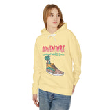 Teen girl in yellow streetwear hoodie with 'Adventure awaits' graphic from TeenHub