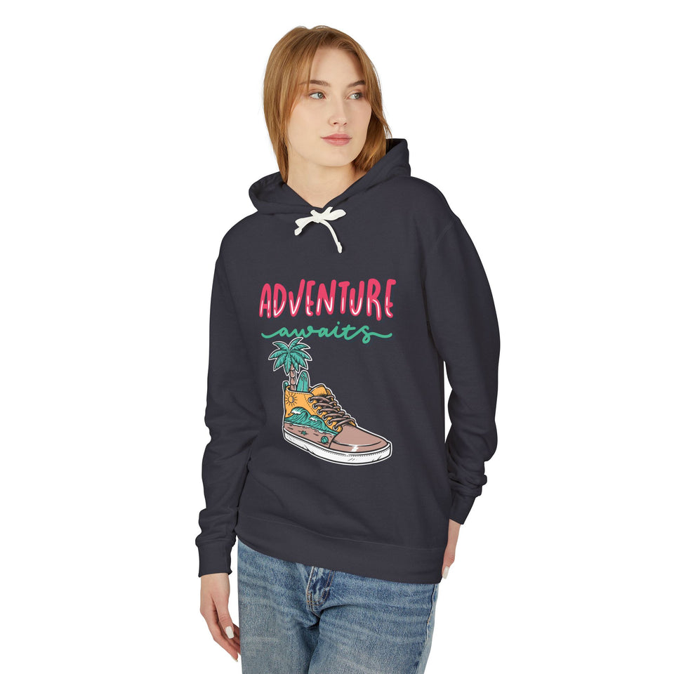 Teen wearing trendy streetwear hoodie with 'Adventure awaits' graphic, casual youth fashion