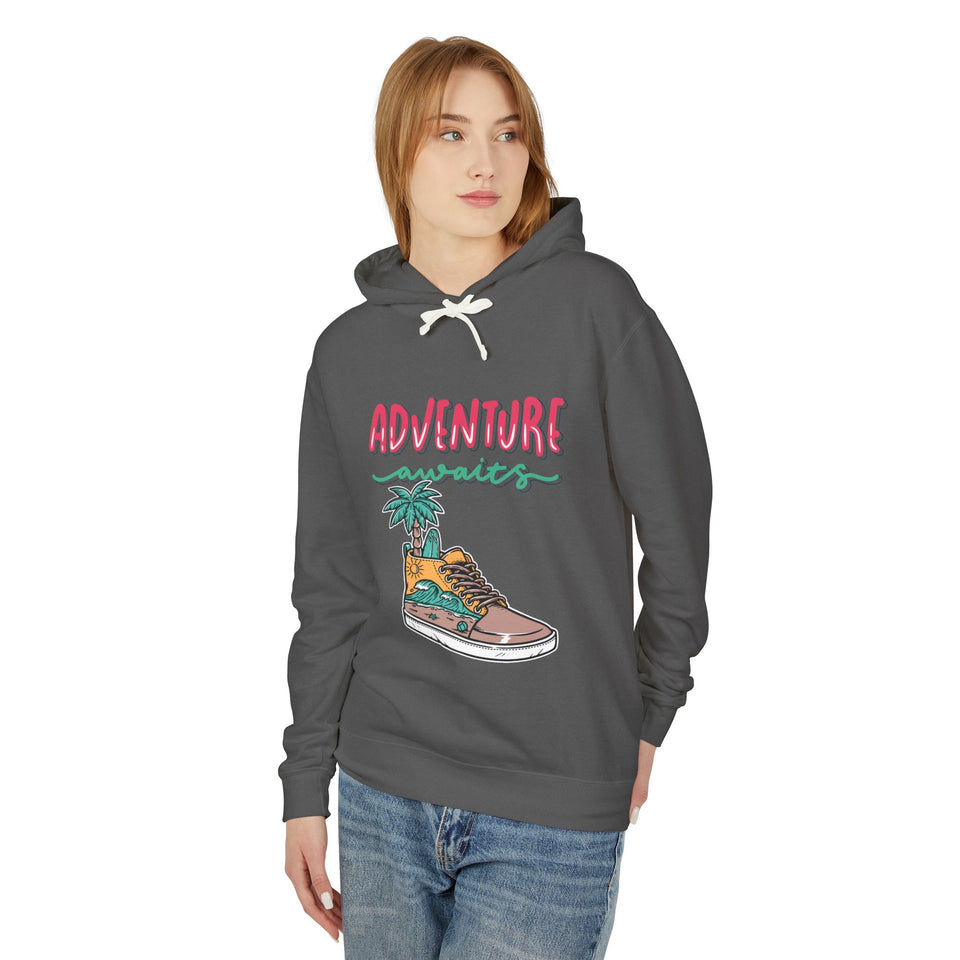 Teen girl in streetwear hoodie with 'Adventure Awaits' graphic, casual youth fashion.